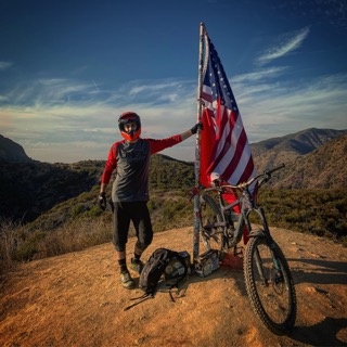 Joshua Shepelsky mountain biking at a trail summit